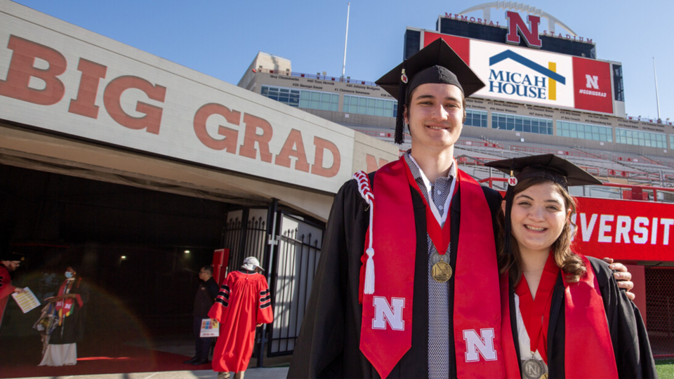 Max and Trinity inside Memorial Stadium for commencement