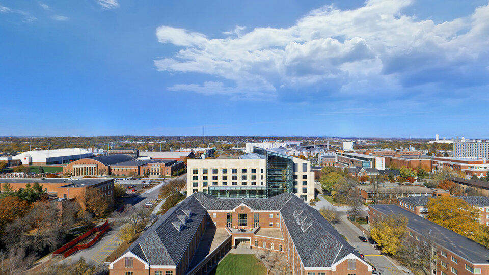 An aerial photograph of a large brick building, with several other buildings surrounding it.