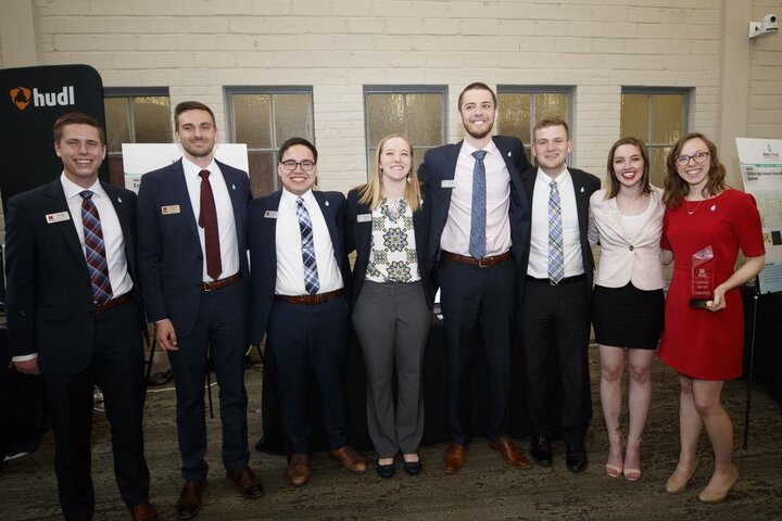 A group of people in suits standing together for a photograph.