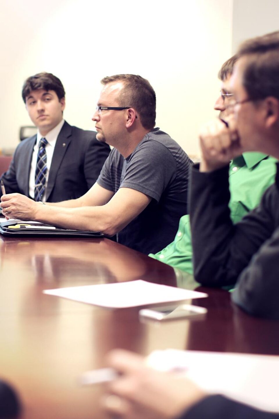 A group of people sat at a conference table.